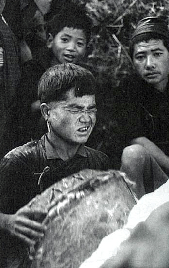 A Kham boy winces as a spirit touches him.
